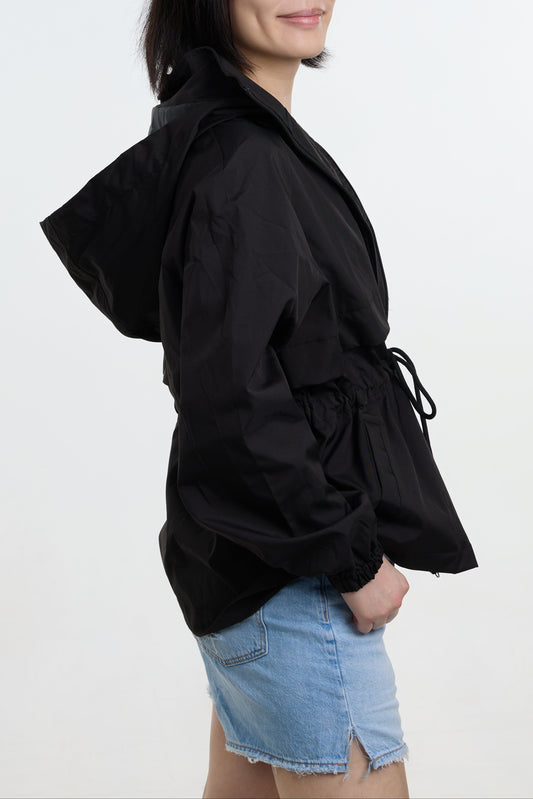 Person wearing a black jacket with a white background