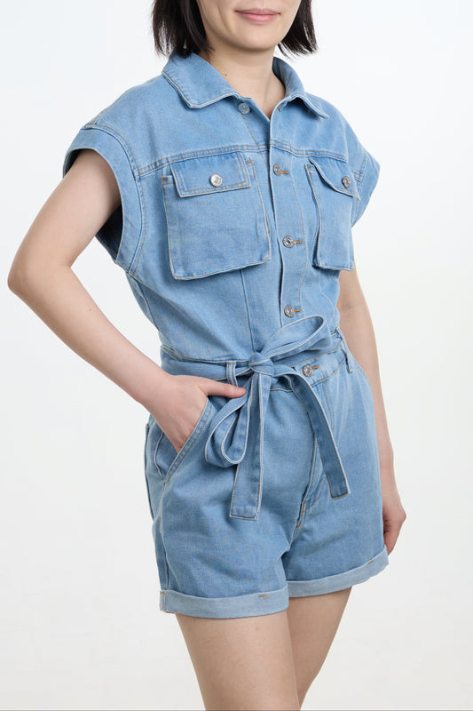Woman wearing a denim romper on a white background